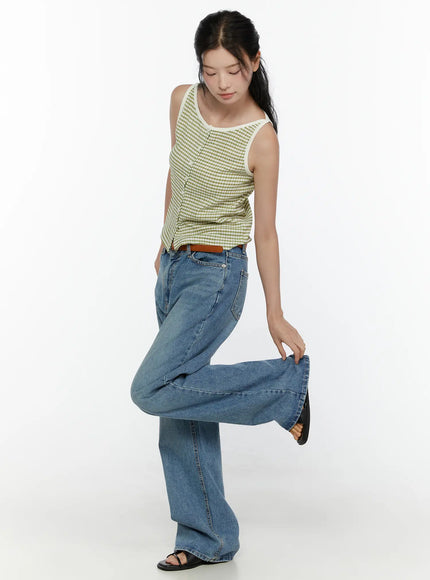 Vienne Wide Leg Jeans CL521 Blue full-body front pose on model lifting wide leg hem to show volume, paired with green gingham top and brown belt