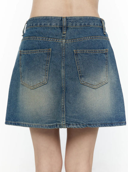 Vintage A-Line Denim Mini Skirt IL506 Blue back close-up detail shot on model showing dual back patch pockets with chevron stitching and sun-faded denim texture