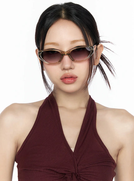 Vintage Cat Eye Fashion Sunglasses CL527 Beige One Size close-up model front facing wearing translucent beige cat-eye frames showing deep V-neck halter top neckline detail