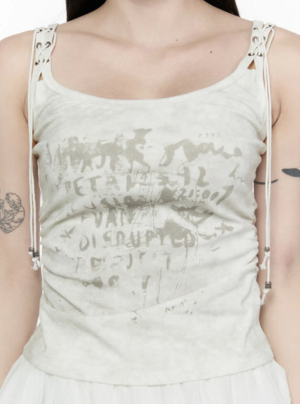 Vintage Graphic Tank Top IL521 Light beige front shot model hand in hair graffiti print lace-up straps side ruching tiered pleated mini skirt half-body view