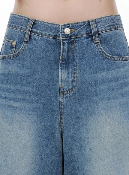 Vintage Wash Jorts IL502 Blue close-up detail of waistband, silver button, front pockets, and contrast yellow stitching on washed denim