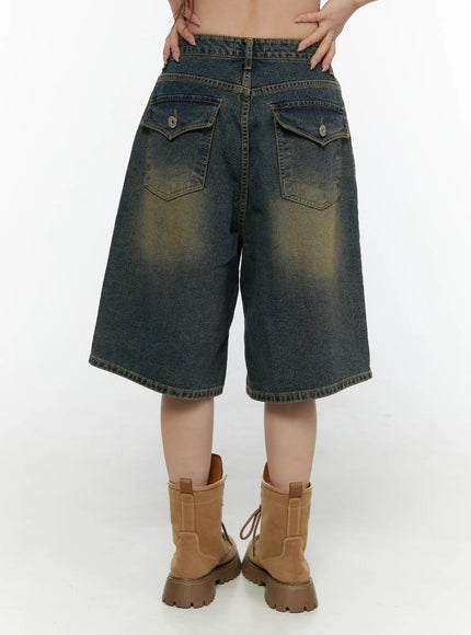 Vintage Washed Jorts CL508 Dark blue back view on model showing dual flap back pockets, wide-leg hem, belt, and tan combat boots