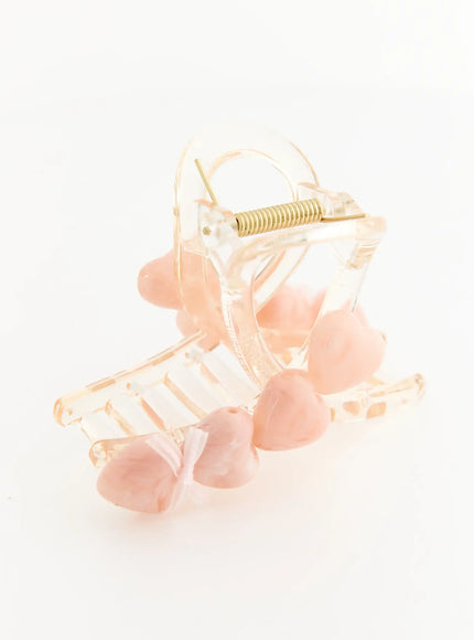 Violet Beige Hair Clip IL503 beige pink side-angle view displaying clear acrylic claw clip frame with pink heart resin studs and gold spring detail