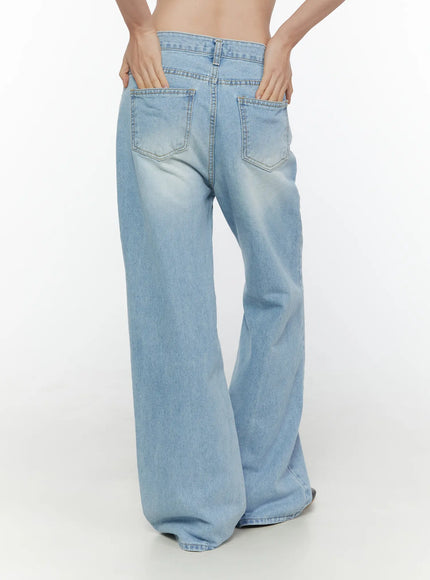 Wade Light Washed Wide Leg Jeans CL520 Light blue back shot on model hands on waistband showing wide leg flare dual back pockets and faded wash denim