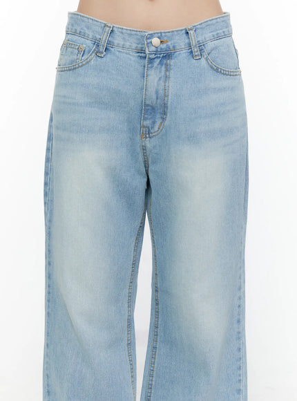 Wade Light Washed Wide Leg Jeans CL520 Light blue close-up front detail shot on model showing low-rise waistband front pockets button and washed denim texture