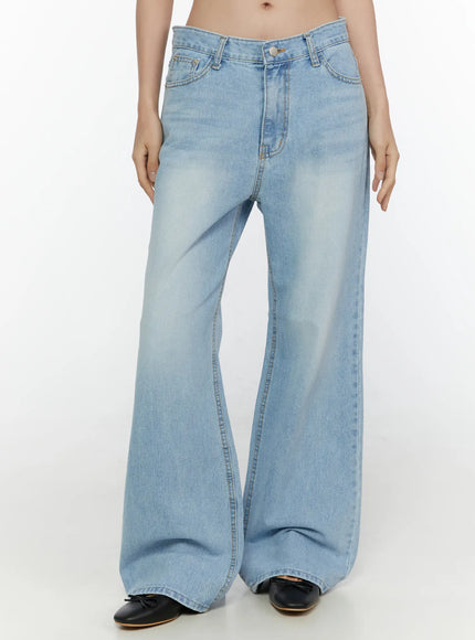 LEWKIN Wade Light Washed Wide Leg Jeans CL520 Light blue front crop shot on model Size S showing low-rise waistband button closure and wide flared denim legs