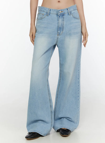 LEWKIN Wade Light Washed Wide Leg Jeans CL520 Light blue front crop shot on model Size S showing low-rise waistband button closure and wide flared denim legs