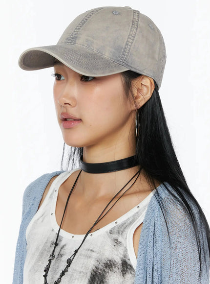 Washed Denim Cap IL509 Gray side portrait on model showing brim profile washed cotton stitching detail blue cardigan styling