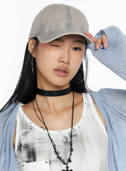 Washed Denim Cap IL509 Gray front close-up on model one eye winking hand touching brim washed faded cotton fabric