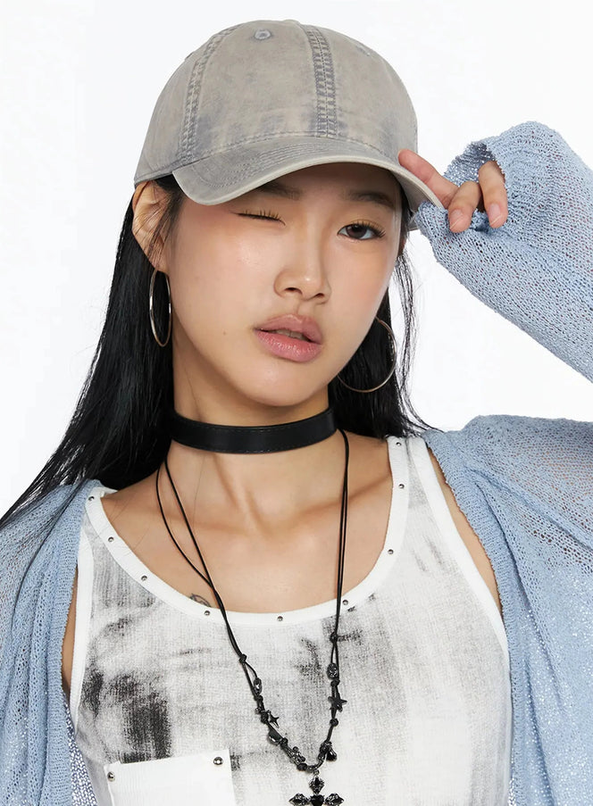 Washed Denim Cap IL509 Gray front close-up on model one eye winking hand touching brim washed faded cotton fabric