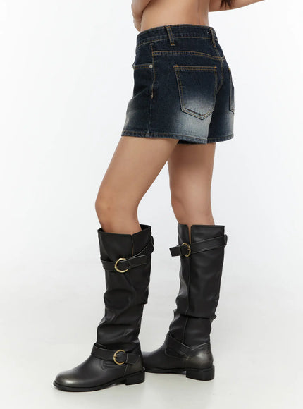 Washed Denim Shorts CU526 Dark blue side shot on model revealing back pocket detail contrast stitching and faded wash texture paired with boots