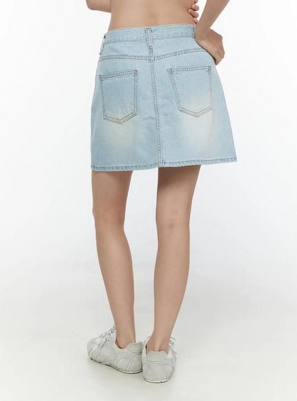 Washed Denim Skirt CL521 Light blue back full model shot on model wearing white sneakers hands on hips showing dual back pockets and faded wash