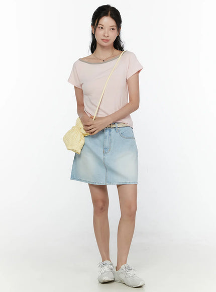 Washed Denim Skirt CL521 Light blue full-body front model shot styled with pink tee belt and yellow crossbody bag standing upright on white background
