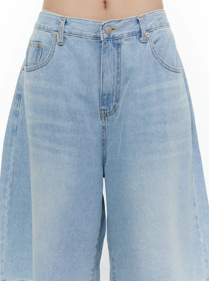 Washed Wide Leg Jorts CL508 Blue close-up detail of waistband, zip fly, silver button, front pockets, and washed denim texture on model
