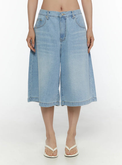 Washed Wide Leg Jorts CL508 Blue front view on model showing full wide-leg silhouette, high waistband, silver button closure, front pockets, and white flip-flop sandals