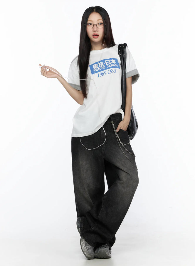 LEWKIN West Wide Leg Jeans CL527 Black S full-body front shot on model styled with white graphic tee, chain accessory, and chunky sneakers
