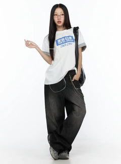 LEWKIN West Wide Leg Jeans CL527 Black S full-body front shot on model styled with white graphic tee, chain accessory, and chunky sneakers