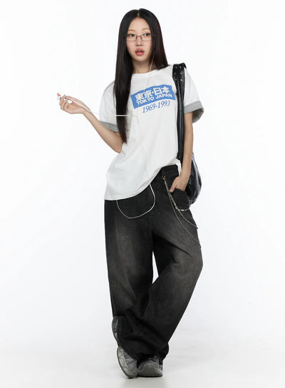 LEWKIN West Wide Leg Jeans CL527 Black S full-body front shot on model styled with white graphic tee, chain accessory, and chunky sneakers