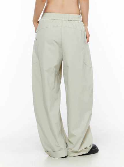 Wide Leg Cargo Pants CL501 Light beige back shot on model showing elastic waistband, back patch pockets with metal snap buttons and wide balloon leg hem