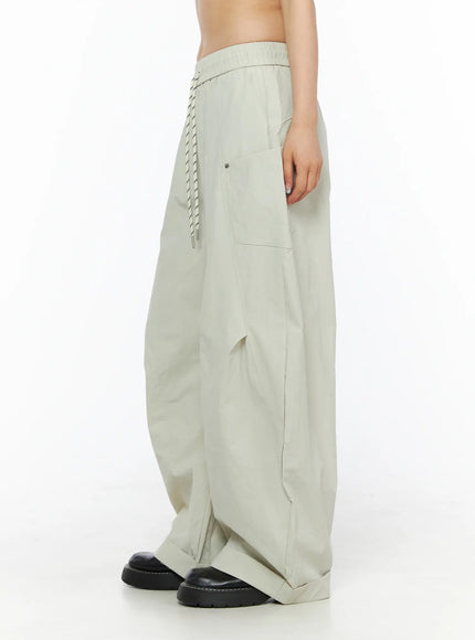 Wide Leg Cargo Pants CL501 Light beige side shot on model showing voluminous wide-leg silhouette, side cargo pocket with snap button and rope drawstring