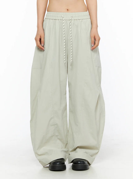 LEWKIN Wide Leg Cargo Pants CL501 Light beige front crop shot on model showing elastic drawstring waistband and wide-leg silhouette in lightweight fabric