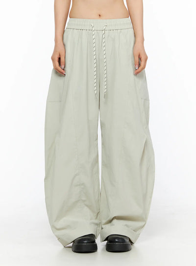 LEWKIN Wide Leg Cargo Pants CL501 Light beige front crop shot on model showing elastic drawstring waistband and wide-leg silhouette in lightweight fabric