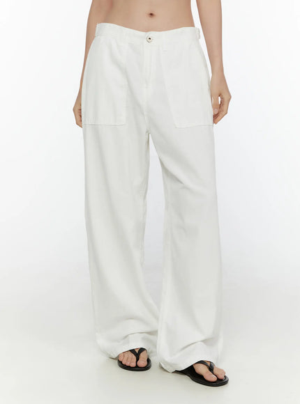 Wide Leg Cotton Pants CL521 White front three-quarter view on model showing patch pockets, relaxed waistband, and wide leg cotton fabric with black sandals