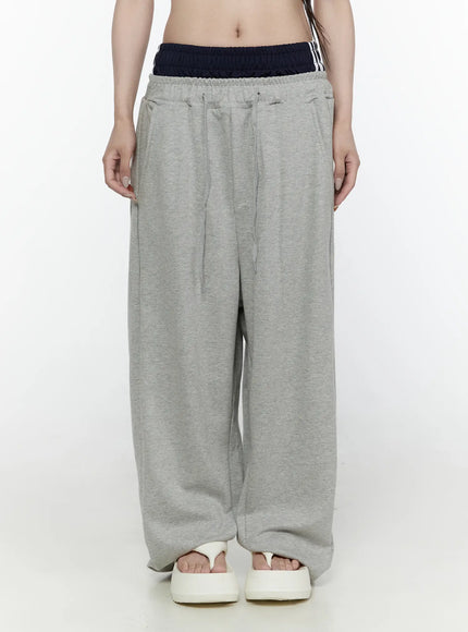 LEWKIN Wide Leg Sweatpants IL522 Gray front shot on model wearing cropped top, navy striped double waistband detail, wide-leg fleece silhouette, white sandals
