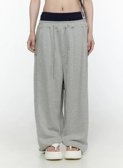 LEWKIN Wide Leg Sweatpants IL522 Gray front shot on model wearing cropped top, navy striped double waistband detail, wide-leg fleece silhouette, white sandals