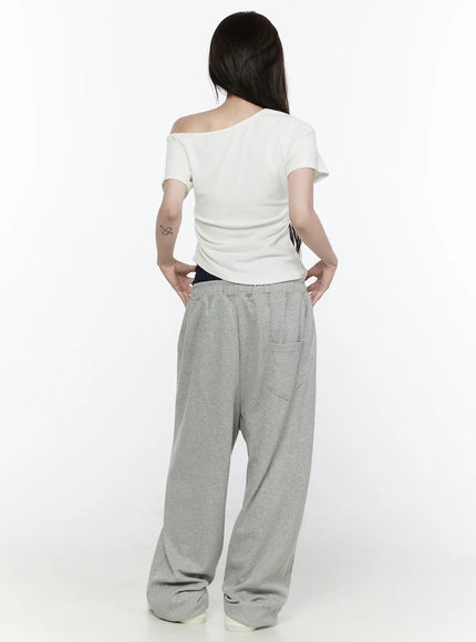 Wide Leg Sweatpants IL522 Gray back shot on model with white off-shoulder top, revealing back patch pocket, elastic waistband, wide-leg heathered gray fabric