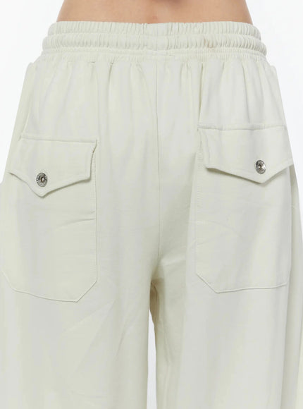 Wide Leg Sweatpants IU524 Light beige close-up back detail of dual cargo patch pockets with silver snap button closures and smocked elastic waistband