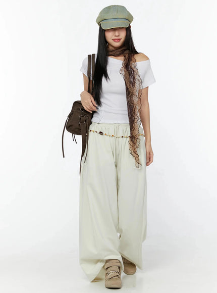 Wide Leg Sweatpants IU524 Light beige full-body front view on model styled with white off-shoulder tee, baker boy cap, lace scarf, bead belt and brown bag