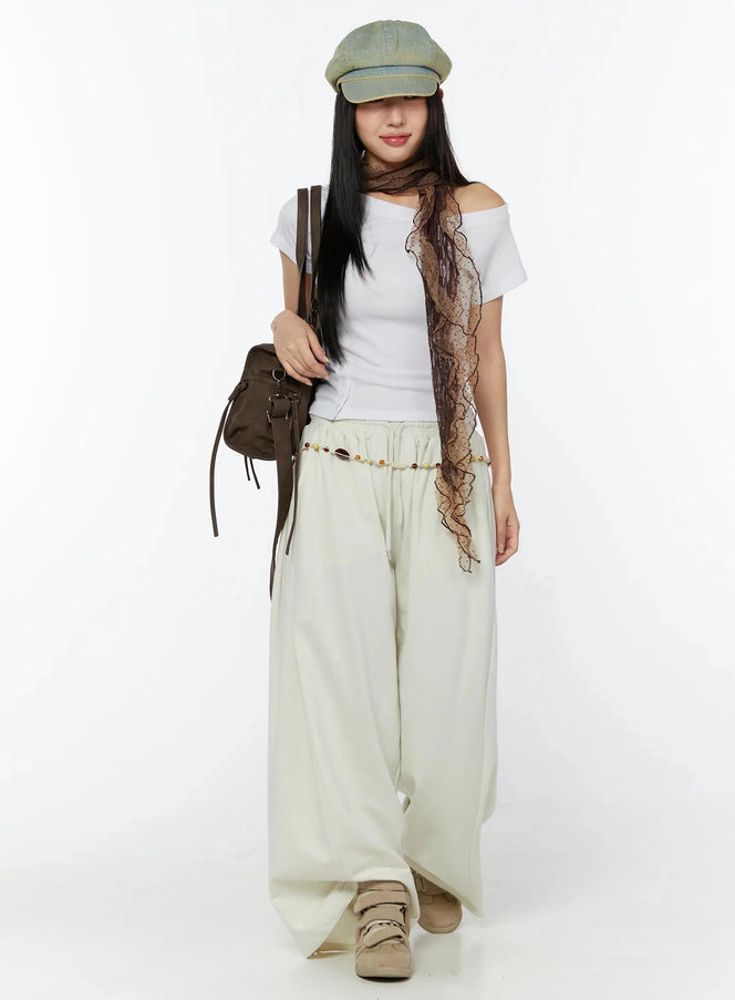 Wide Leg Sweatpants IU524 Light beige full-body front view on model styled with white off-shoulder tee, baker boy cap, lace scarf, bead belt and brown bag