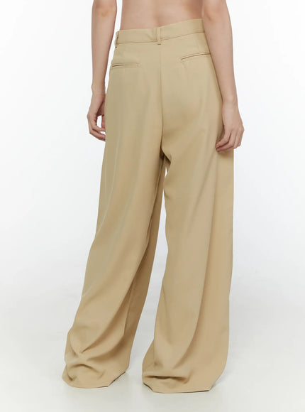 Wide Leg Tailored Pants CL520 Beige back view on model showing smooth fabric drape rear welt pockets and wide flared leg styled with striped top and tote bag