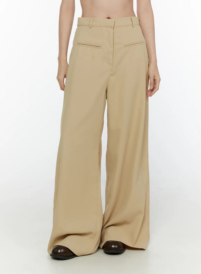 LEWKIN Wide Leg Tailored Pants CL520 Beige front view on model cropped at waist showing high waist belt loops and wide leg silhouette with dark loafers