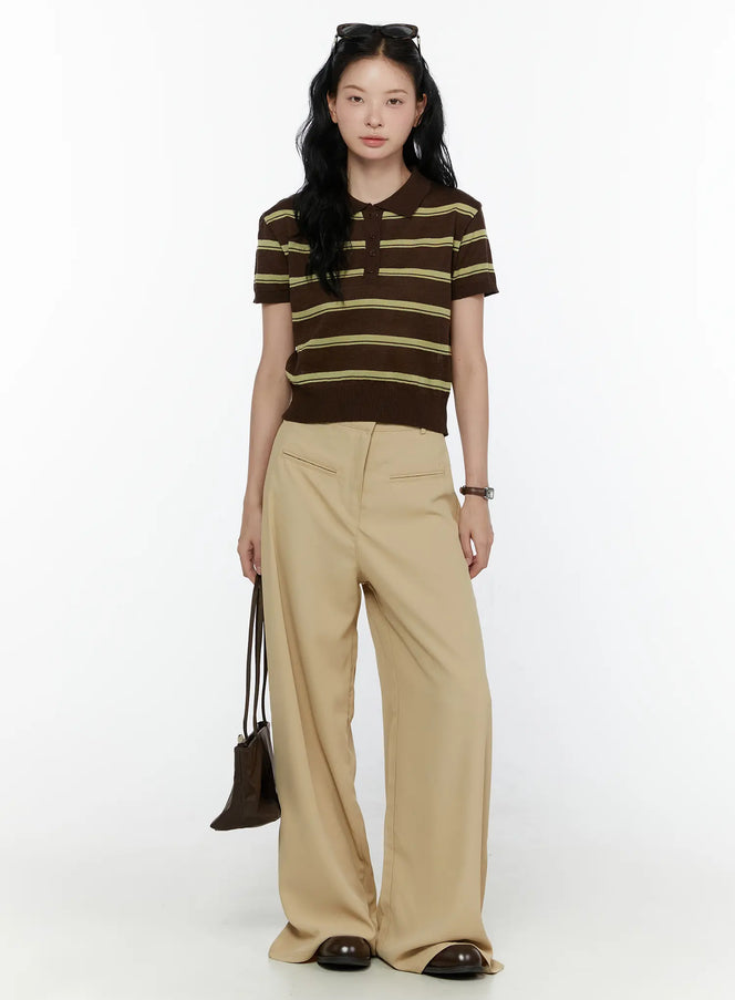 Wide Leg Tailored Pants CL520 Beige full-length front styling shot on model wearing striped polo top holding brown bag with sunglasses on head