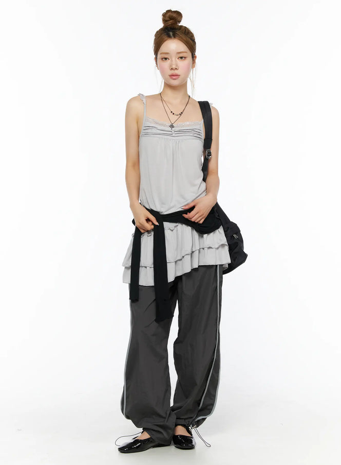 Wide Leg Track Pants CL501 Dark gray full-body front styling shot on model with bun updo, paired with gray ruffle cami top and black bag