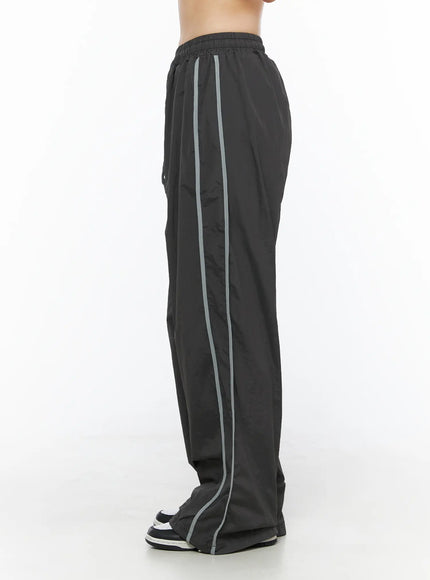 Wide Leg Track Pants CL501 Dark gray side view on model, clean straight side stripe detail visible, wide-leg nylon parachute trousers