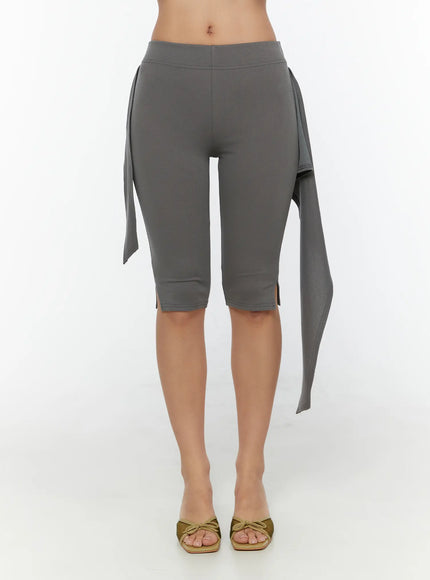 Wrap Capri Pants CU526 Dark gray front shot model showing untied wrap skirt panel with fabric sash hanging freely on both sides revealing legging underneath