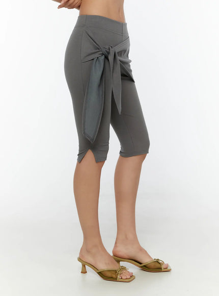 Wrap Capri Pants CU526 Dark gray side shot model showing tie knot wrap skirt drape over stretch capri leggings with slit hem