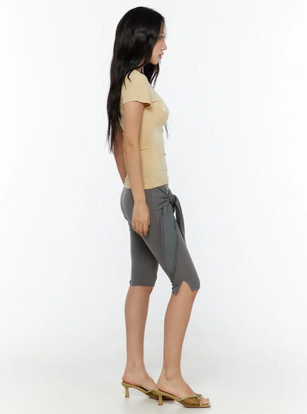 Wrap Capri Pants CU526 Dark gray side full-length shot model in beige top showing tie wrap skirt silhouette and capri legging fit from side angle