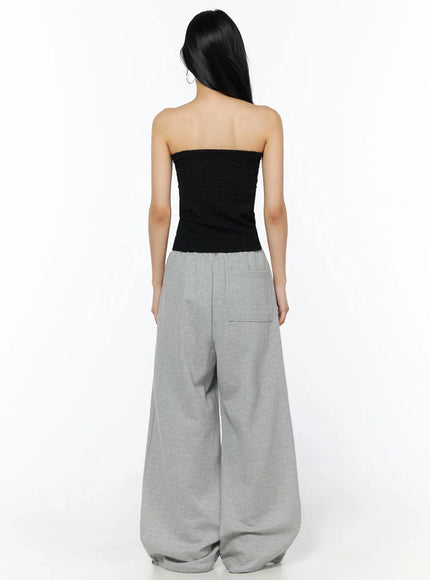 Wrinkle Textured Tube Top IL516 Black back shot on model revealing textured back panel, paired with grey wide-leg sweatpants showing back pocket