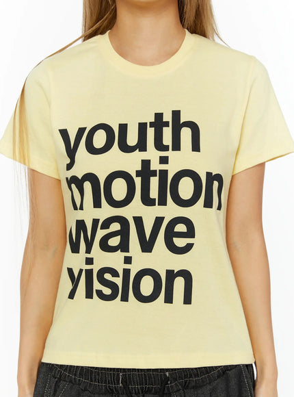 Youth Graphic Short Sleeve Tee IL524 Yellow close-up detail shot on model showing bold black youth motion wave vision graphic print and crew neckline