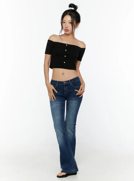 Zainab Low-Rise Flared Bootcut Jeans CU529 Dark blue full-body front shot on model in black off-shoulder crop top, standing straight with hands on hips