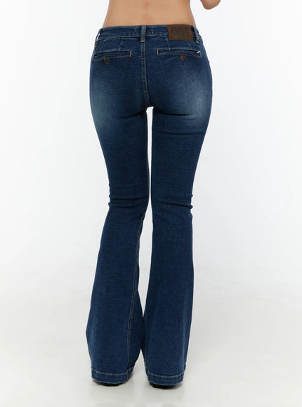 Zainab Low-Rise Flared Bootcut Jeans CU529 Dark blue back shot on model showing button-flap rear pockets, leather logo patch, and wide flared hem