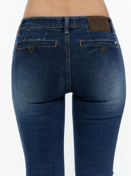 Zainab Low-Rise Flared Bootcut Jeans CU529 Dark blue close-up back shot on model showing button-closure flap pockets, leather logo patch and washed denim texture