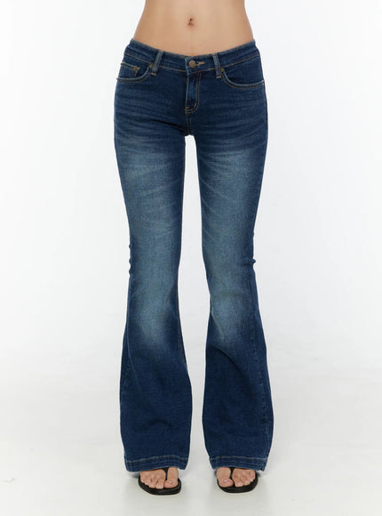 Zainab Low-Rise Flared Bootcut Jeans CU529 Dark blue front shot on model from waist down, standing in flip-flops showing full flared bootcut length and washed finish