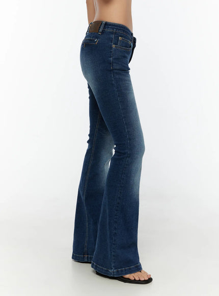 Zainab Low-Rise Flared Bootcut Jeans CU529 Dark blue side shot on model showing slim thigh to flared bootcut silhouette with leather brand patch at waistband