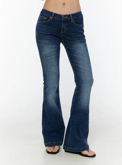 LEWKIN Zainab Low-Rise Flared Bootcut Jeans CU529 Dark blue front crop shot on model wearing flip-flops, low-rise waistband with gold stitching and flared hem