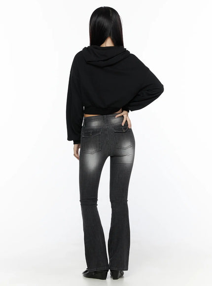 Zip-Up Crop Hoodie CL527 Black back shot on model showing hood and cropped silhouette with ribbed hem over gray flare jeans